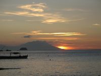 The sun sinks in the South China Sea just behind Mount Kalawite.